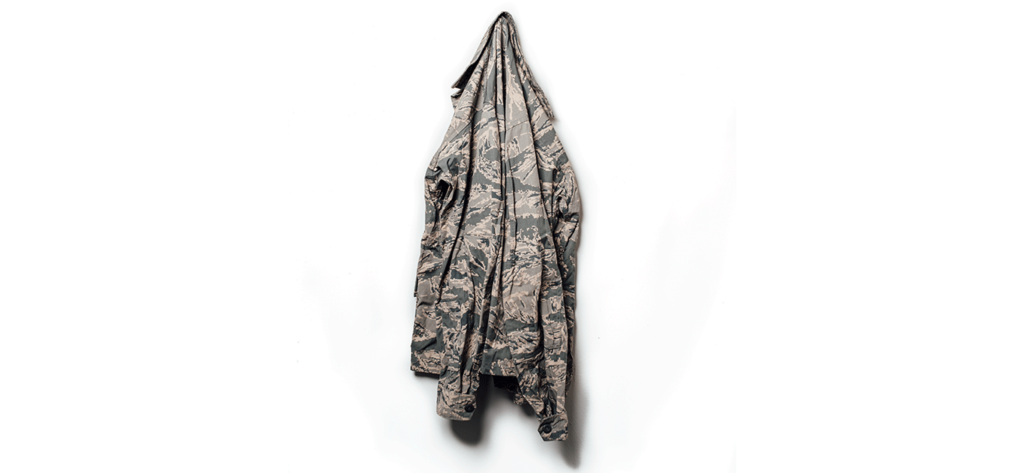 camo coat hanging on a white wall