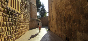woman walking through a stone alleyway
