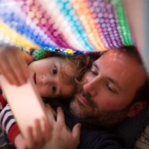 A father watches a video with his child